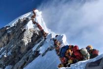 In a May 22, 2019 photo, a long queue of mountain climbers line a path on Mount Everest. About ...