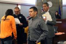 Ryan Mansour, center, charged with attempted murder for driving over his girlfriend after she a ...