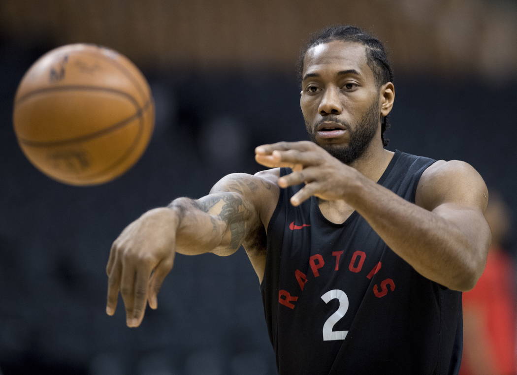 Toronto Raptors' Kawhi Leonard passes during practice for the NBA Finals in Toronto on Wednesda ...