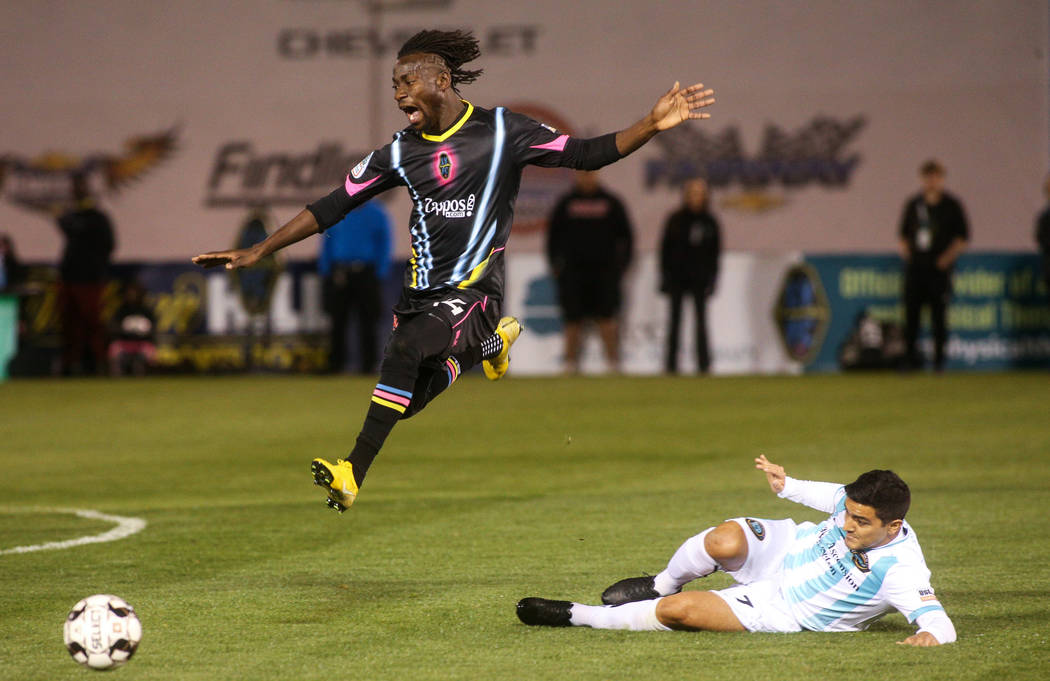 Las Vegas Lights FC midfielder Alex Nyarko Harlley (14) jumps over Austin Bold FC forward Julia ...