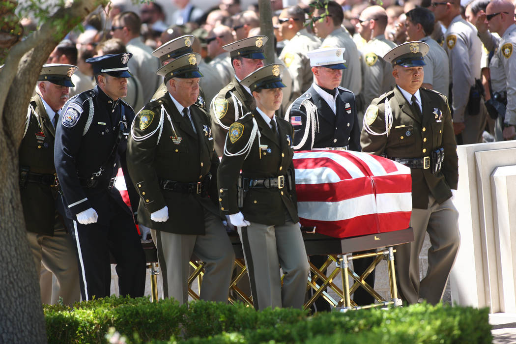 Honor guard officers escort the casket of fallen Las Vegas police officer Alyn Beck during fune ...