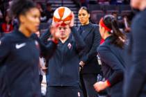 Las Vegas Aces center Liz Cambage (wearing street clothes) watches her teammates warm up before ...