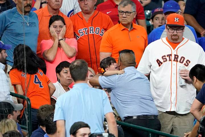 A young child is carried from the stands after being injured by a foul ball off the bat of Chic ...