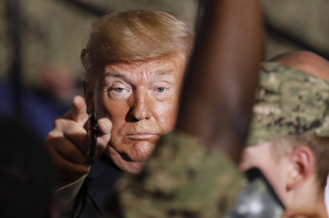 U.S. President Donald Trump gestures to U.S. servicemen at U.S. Navy multipurpose amphibious as ...