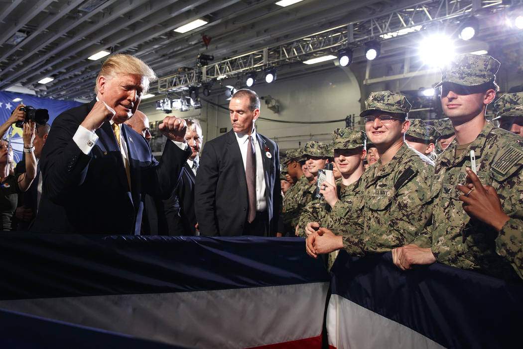 President Donald Trump greets troops after speaking at a Memorial Day event aboard the USS Wasp ...