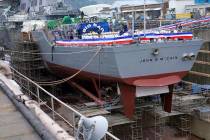 The USS John S. McCain under repair at a dry dock is seen prior to the rededication ceremony fo ...