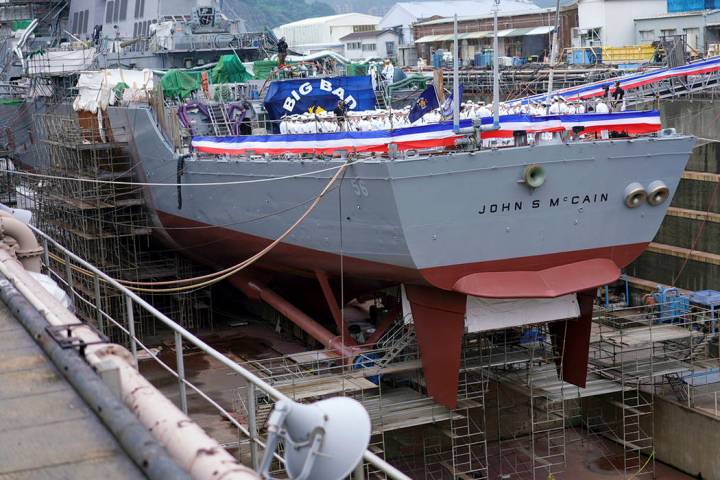 The USS John S. McCain under repair at a dry dock is seen prior to the rededication ceremony fo ...
