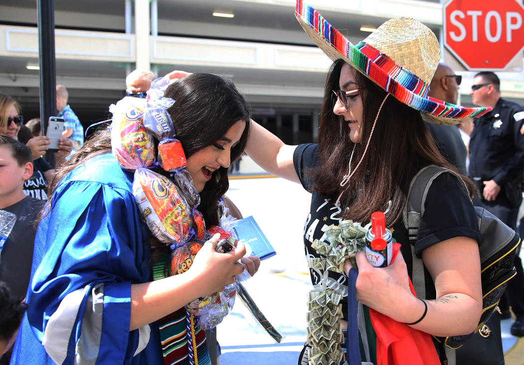 College of Southern Nevada High School student Itzel Sinoto, left, receives graduation leis fro ...