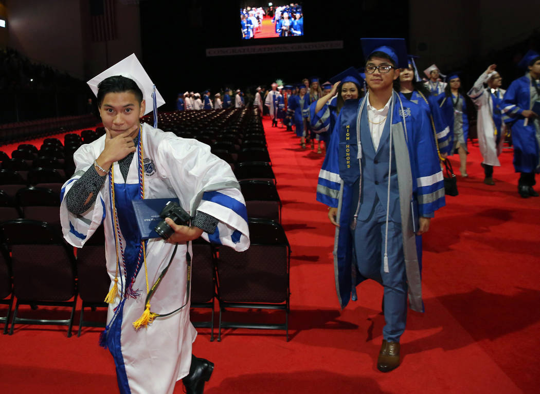 College of Southern Nevada High School student Carl Tiglao reacts after receiving her diploma d ...