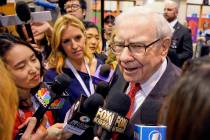 Warren Buffett, Chairman and CEO of Berkshire Hathaway, speaks to reporters during a tour of th ...