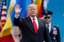 President Donald Trump waves as he takes the stage to speak at the U.S. Air Force Academy gradu ...