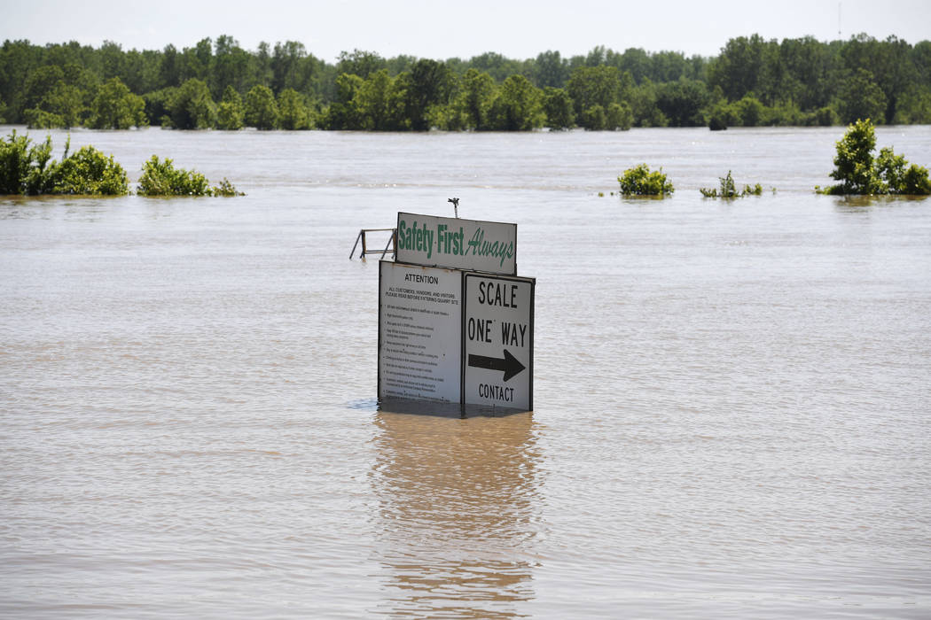 The Arkansas River floods along Adams Street Thursday, May 30, 2019, in Van Buren, Ark. (AP Pho ...