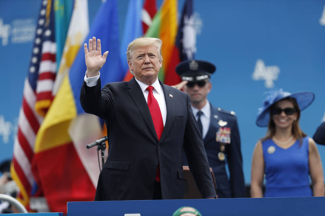 President Donald Trump waves as he takes the stage to speak at the U.S. Air Force Academy gradu ...