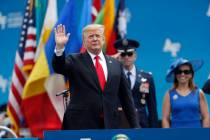 President Donald Trump waves as he takes the stage to speak at the U.S. Air Force Academy gradu ...