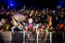 Attendees headbang as Excision performs at the Kinetic Field stage during the first day of the ...