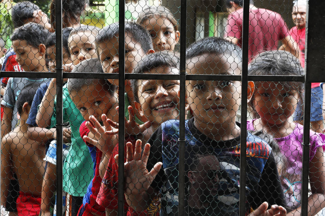 Migrant children line up for a meal at the door of the Jesus del Buen Pastor del Pobre y el Mig ...
