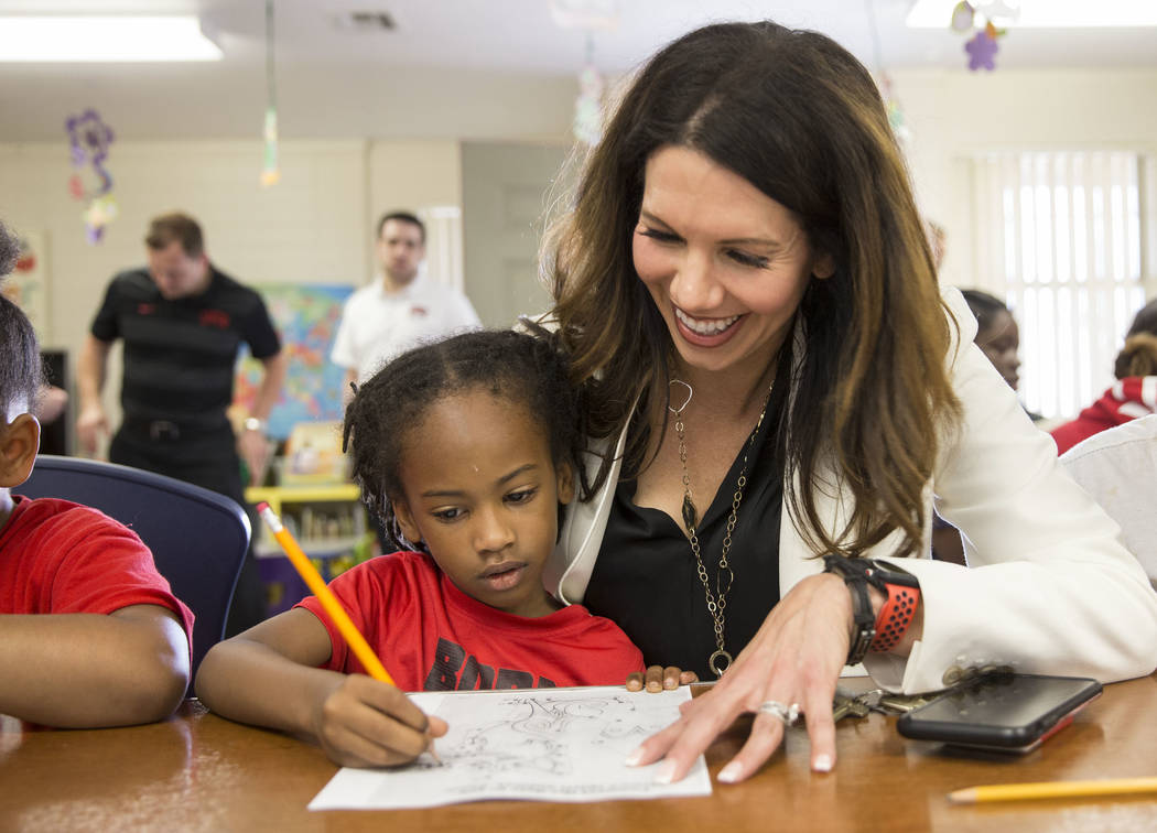 UNLV athletic director Desiree Reed-Francois, right, helps Jayceon Jackson, 6, with her homewor ...