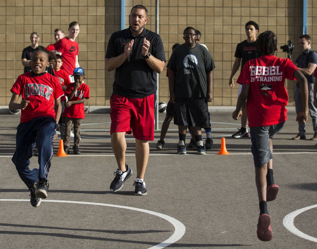 UNLV assistant coach DeShawn Henry, center, cheers on kids with the Nevada Youth Network during ...