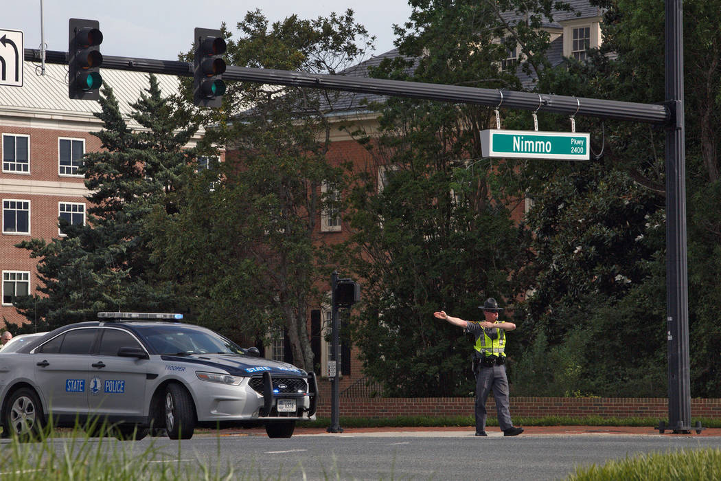 A police officer directs traffic away from the intersection of Princess Anne Road and Nimmo Par ...