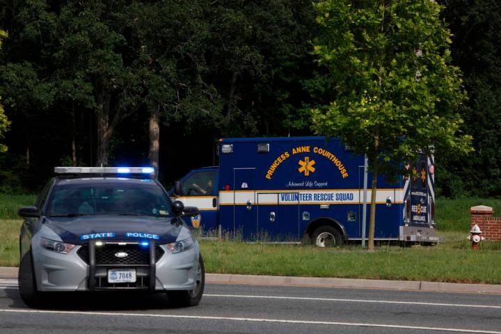An ambulance turns on Nimmo Parkway following a shooting at the Virginia Beach Municipal Center ...