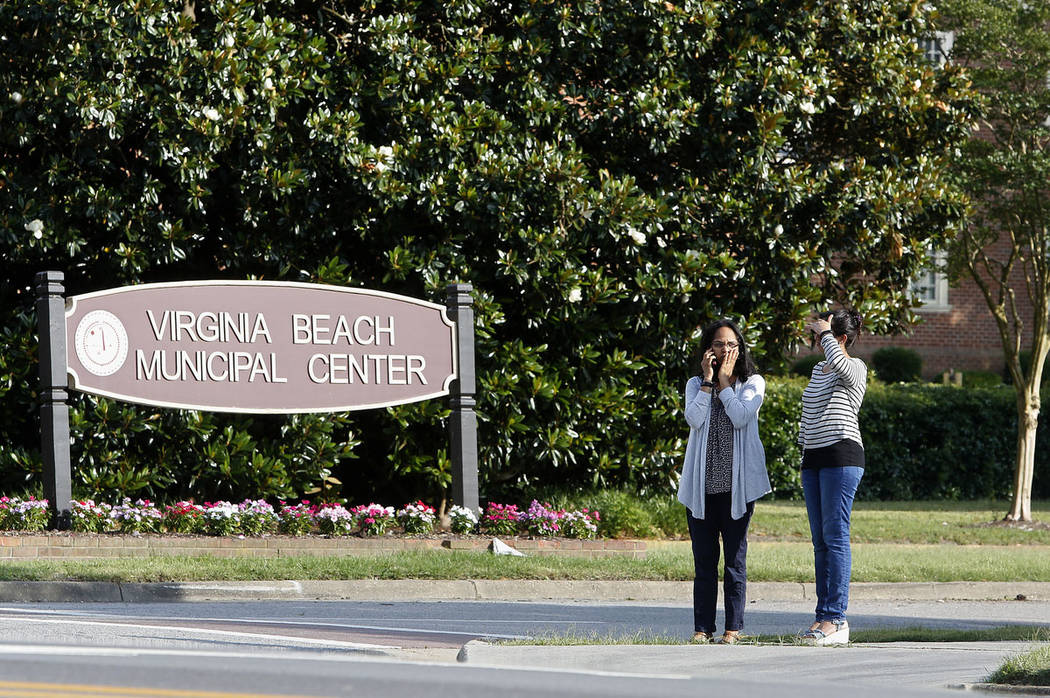 Women wait by an entrance to the Virginia Beach Municipal Center on Princess Anne Road followin ...