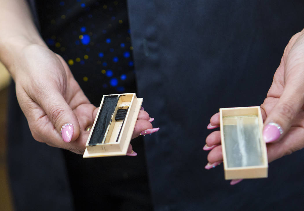 Deirdre Clemente, associate director of the UNLV public history program, shows mascara from Cla ...