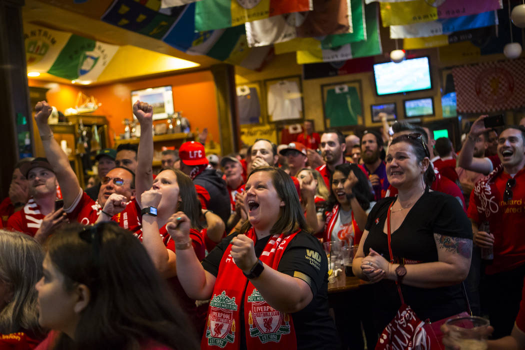 Liverpool fan Shannon Theobald, of Cleveland, celebrates a penalty that was called at the start ...