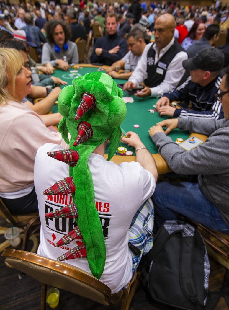 Ian "Aces" Sweden, of Kirkcady, Scotland, wears a dragon hat during the The Big 50, a ...