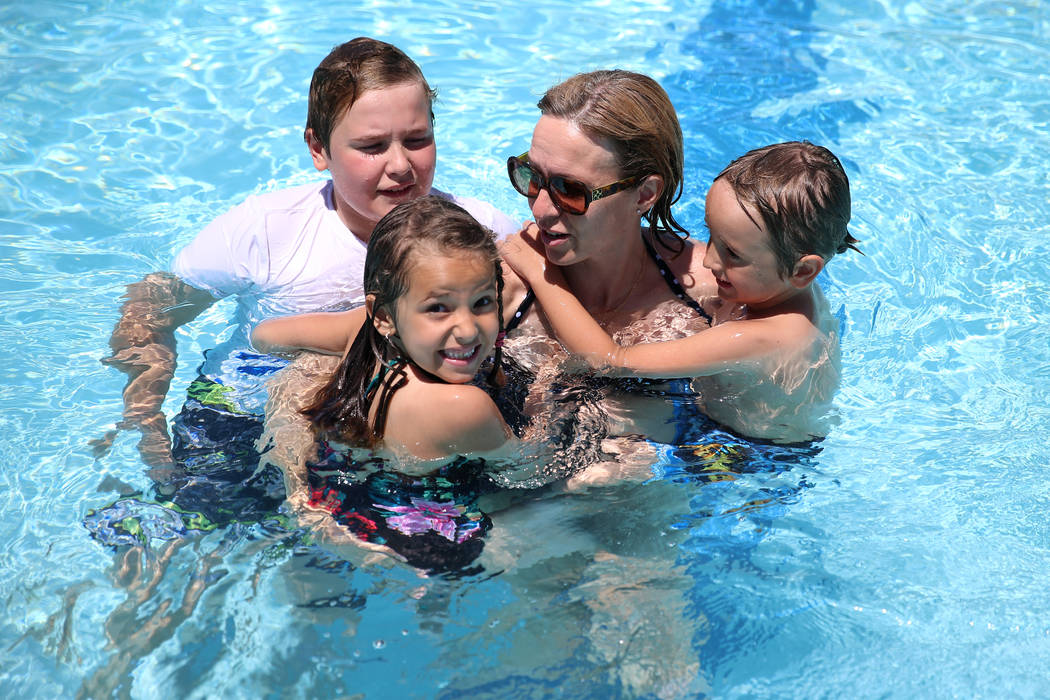 Lisa Knopf, with her children from from left, Martin ,13, AJ, 6, and Adam 4, swim during the an ...