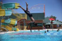 Elijah Smith, 11, leaps into the pool during the annual Ward 4 Summer Splash at the Durango Hil ...
