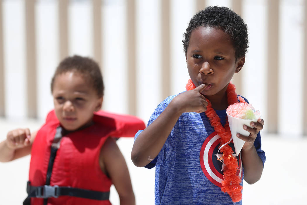 Jared Thornton, right, 7, with his brother Jorge, 2, eats an ice cone during the annual Ward 4 ...