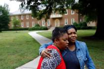Shelia Cook, left, and Renee Russell, members of Mount Olive Baptist Church, embrace after pray ...