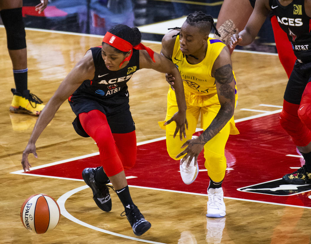 Las Vegas Aces guard Sydney Colson (51) steals the ball from Los Angeles Sparks guard Riquna Wi ...