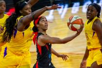 Las Vegas Aces guard Sydney Colson (51) gets off a reverse layup past Los Angeles Sparks center ...