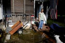 Connie Sollars stands on the porch of her wet front yard in west Tulsa, Okla., Friday, May 31, ...
