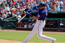 Texas Rangers' Joey Gallo connects for a two-run home run on a pitch from Kansas City Royals' H ...