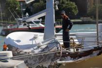 An Italian Coast Guard officer stands on the tourist boat that was struck by a cruise line ship ...