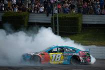 Kyle Busch celebrates after winning a NASCAR Cup Series auto race at Pocono Raceway, Sunday, Ju ...