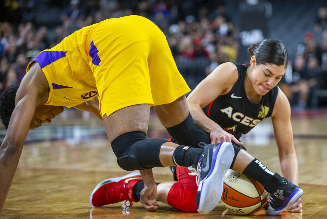 Los Angeles Sparks guard Alexis Jones, left, loses the ball to Las Vegas Aces guard Kelsey Plum ...