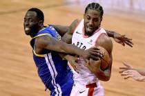 Golden State Warriors forward Draymond Green (23) tries to take the ball from Toronto Raptors f ...
