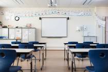 School desk and chairs in empty modern classroom. (Getty Images)