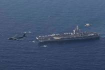 The USS Abraham Lincoln carrier and a U.S. Air Force B-52H Stratofortress, conduct joint exerci ...