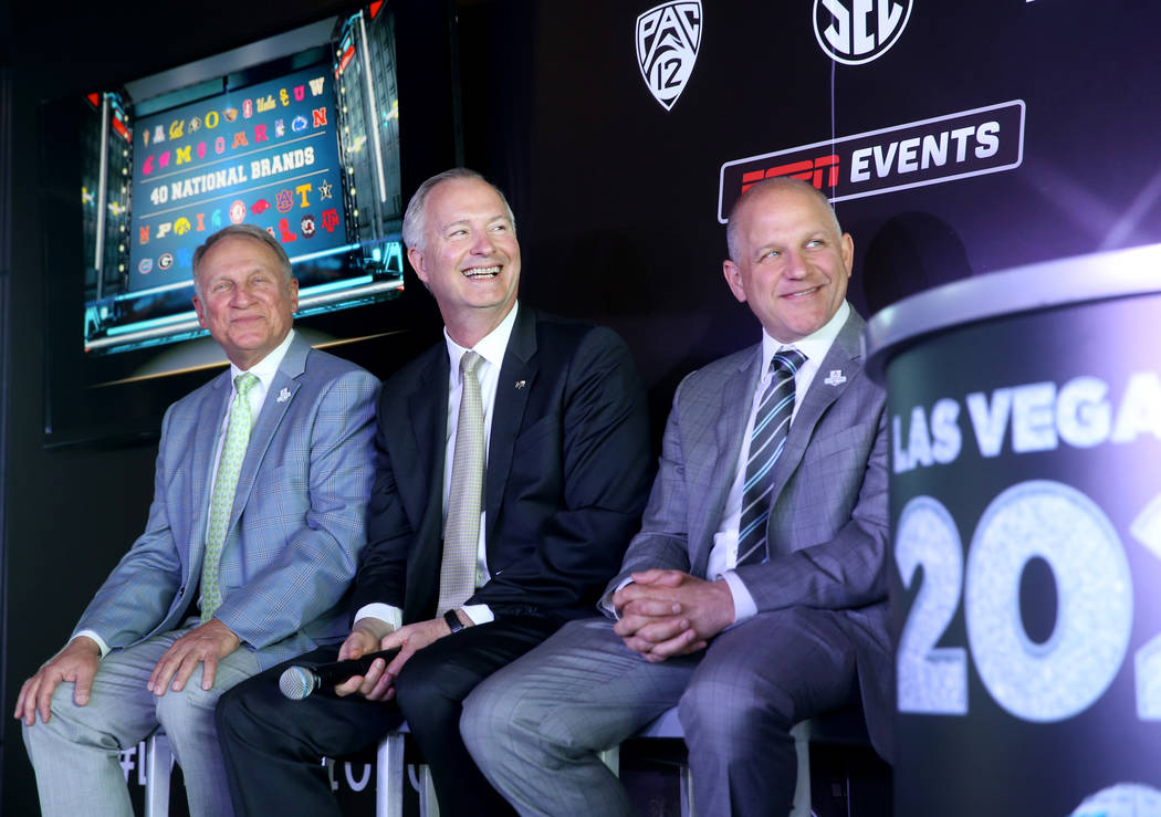 Pete Derzis of ESPN Events, from left, Steve Hill, CEO and president of the Las Vegas Conventio ...