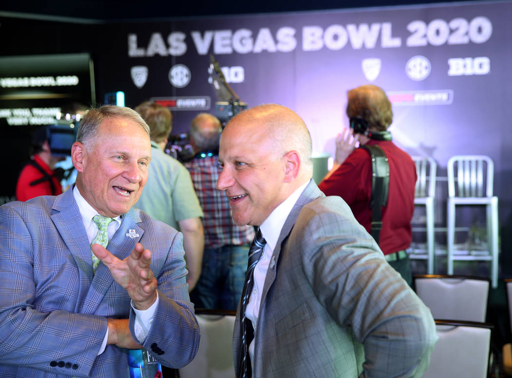 Pete Derzis of ESPN Events, left, and Raiders President Marc Badain, during announcement for th ...