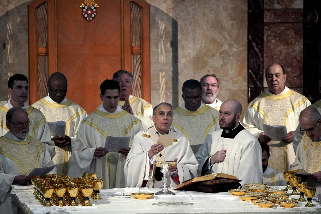 Cardinal Daniel DiNardo presides over a Mass of Ordination for seven candidates for the priesth ...