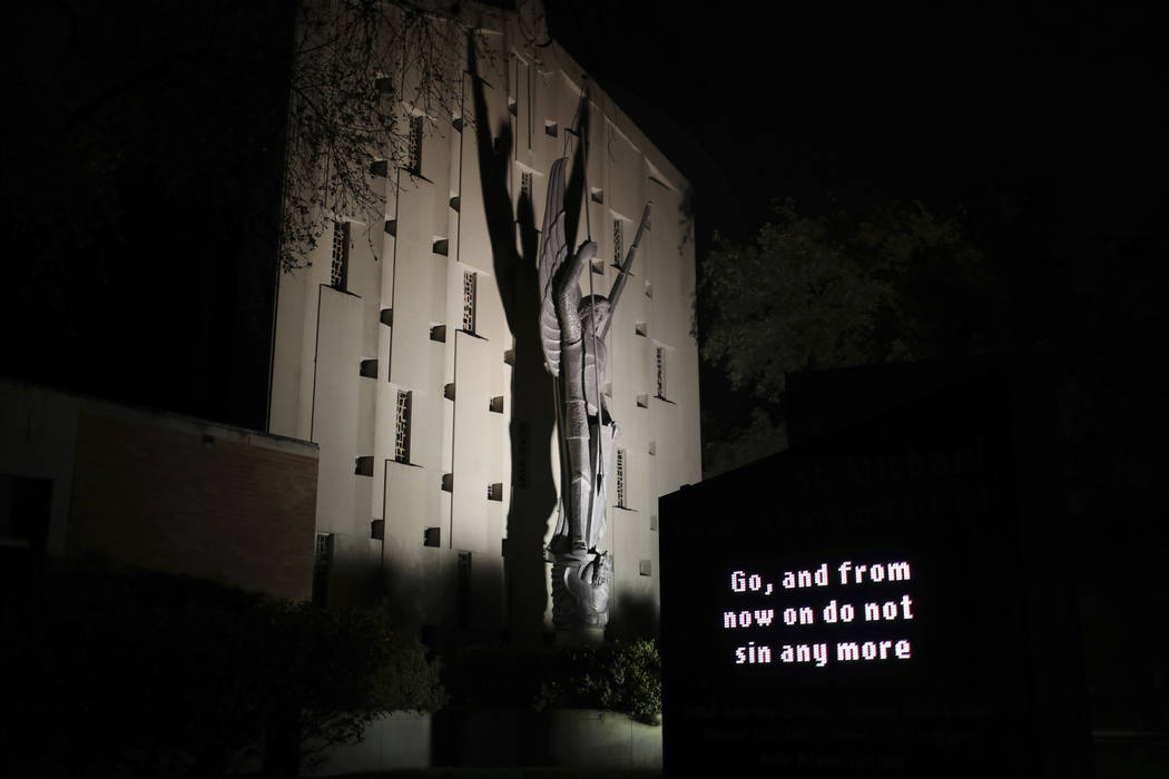 An illuminated sign outside St. Michael Archangel Catholic Church in Houston reads, "Go, a ...