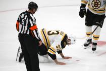 Boston Bruins defenseman Zdeno Chara, of Slovakia, kneels on the ice after being hit in the fac ...