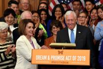 House Speaker Nancy Pelosi of Calif., front left, shakes hands with House Minority Whip Steny H ...