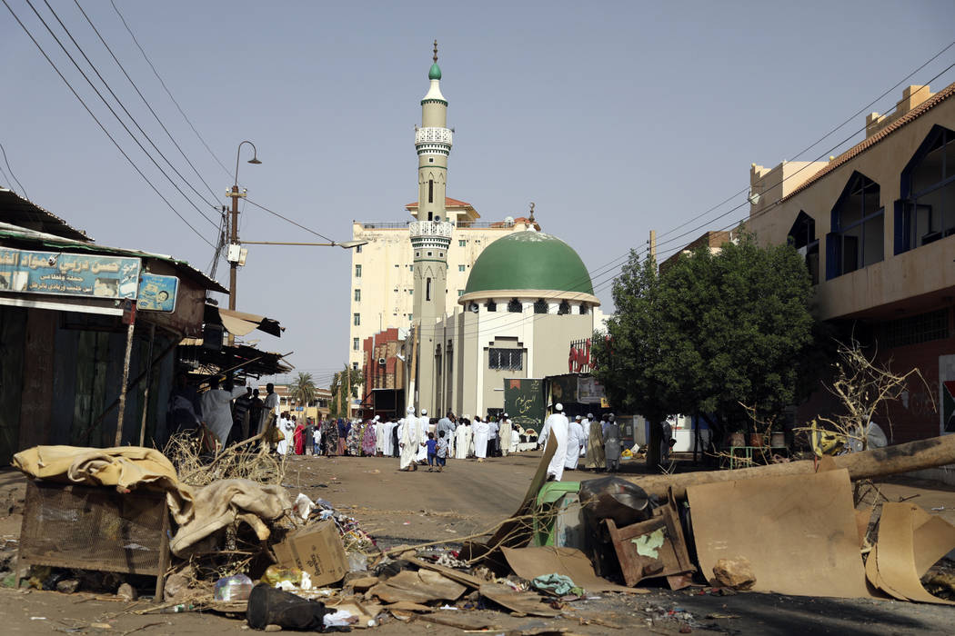 Worshippers gather at a mosque behind a roadblock set by protesters on a main street in the Sud ...