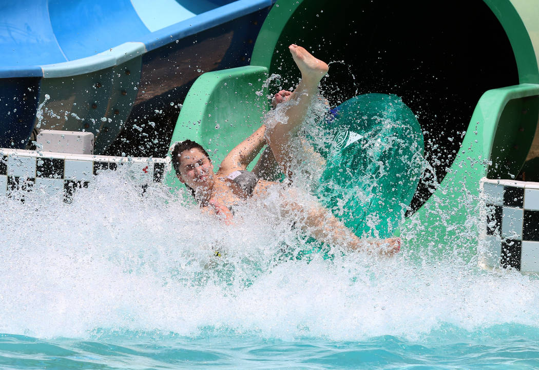 Alex Gentile of Henderson splashes as she rolls down a water slide at Cowabunga Bay Water Park ...